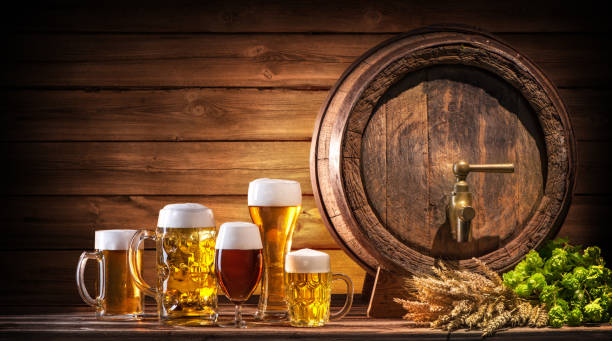 Beer Fest beer barrel and beer glasses Beer Fest beer barrel and beer glasses with wheat and hops on wooden table oktoberfest beer stock pictures, royalty-free photos & images