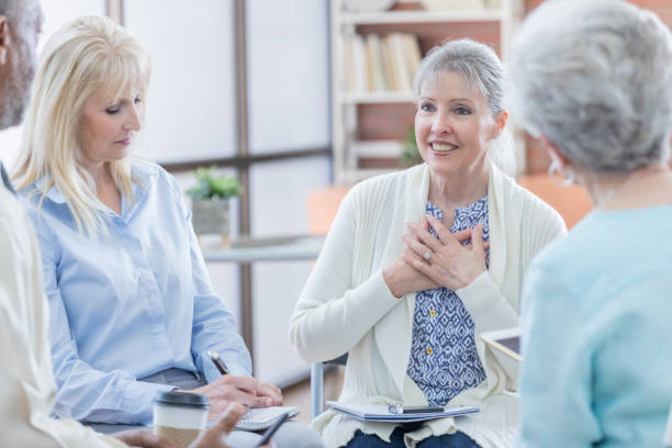 istock Senior woman discusses her emotions during support group 687663070