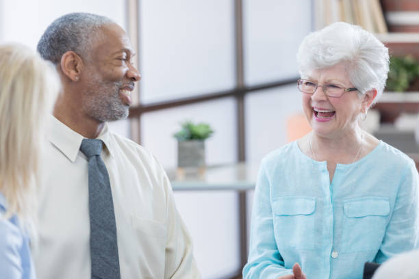 istock Beautiful senior woman laughs during support group meeting 687663086