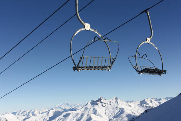 istock Sky lift with snowy mountain 687674832
