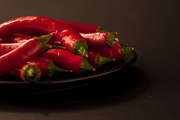 red Chili peppers on a black background