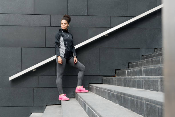 istock Female jogger resting after running, standing on staircase 687674896