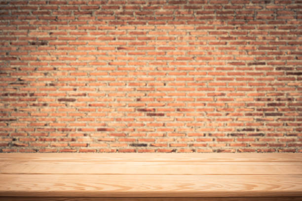 istock wood table top on brick wall background,Space available for the product 687678114