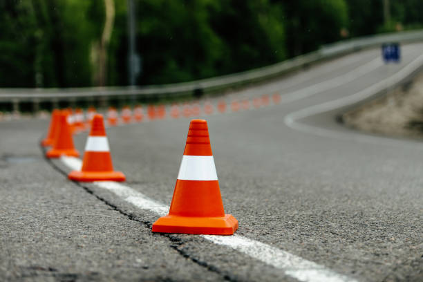 istock bright orange traffic cones on dark asphalt serpentine mountain roads 687678572