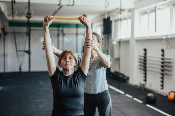 istock Women in the gym workout with resistance bands 687678838