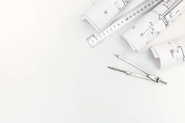 istock rolls with architectural plans and schemes with drawing compass and metal ruler on white background 687679270