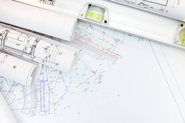 istock architect workplace with rolled plans, housing schemes and spirit level 687685380