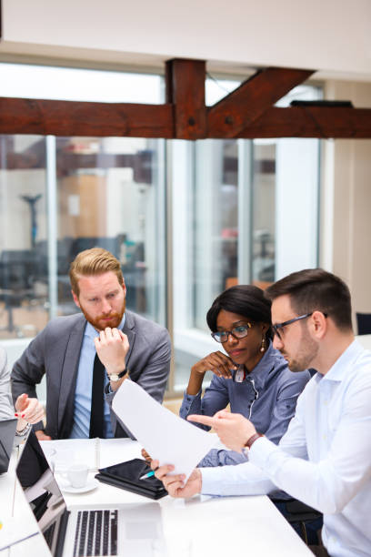 business people discussing strategy with a financial analyst - business vertical talking usa imagens e fotografias de stock