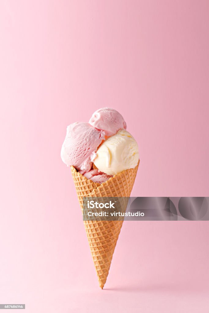 Ice cream cone vanilla and strawberry flavors on a pink background. Copy space Ice Cream Stock Photo