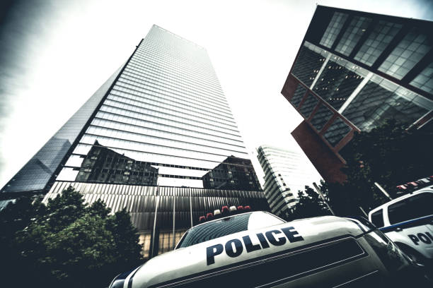 istock Police car parked under financial skyscraper 687686538