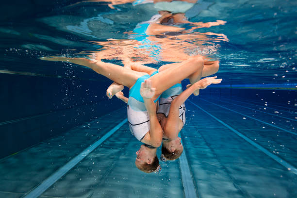 istock Women in Sport, underwater synchronized swimming 687686558