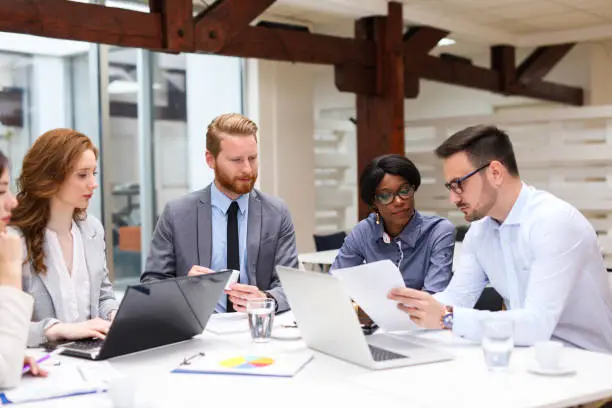 Photo of Business people discussing strategy with a financial analyst