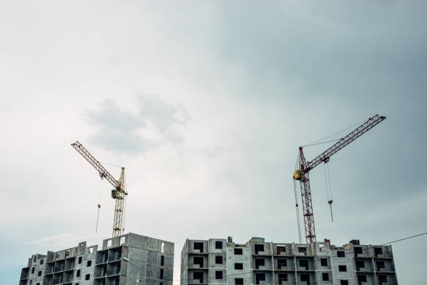 istock The process of building a multi-storey building. Lifting cranes against the sky. 687690002