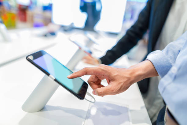 istock customer choosing a new mobile phone in a shop 687690268