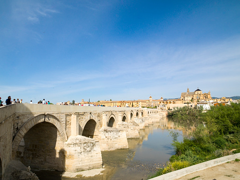 The Roman Bridge of Cordoba, Andolusia, Spain. The Roman bridge which, according to the Arab geographer, Al-drisi surpasses all other bridges in beauty and solidity, reflects little of its Roman roots. Bridge on river.