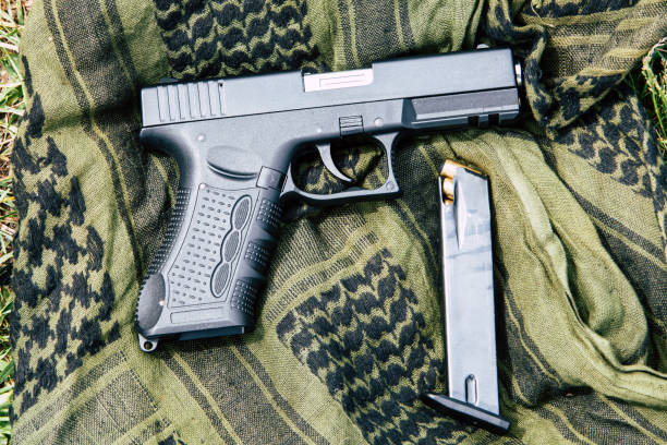 istock A pistol with a magazine on a green background 687695526