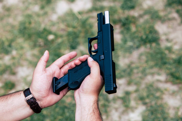 istock Recharge the gun in hand. Training on shooting 687695786