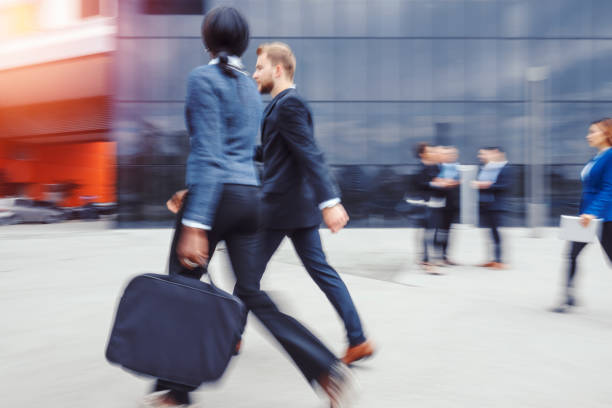 Low section of businessman with briefcase walking down corridor