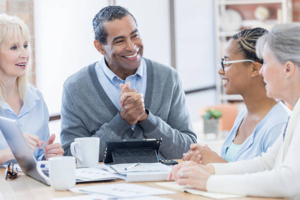istock Confident businessman leads meeting 687698368