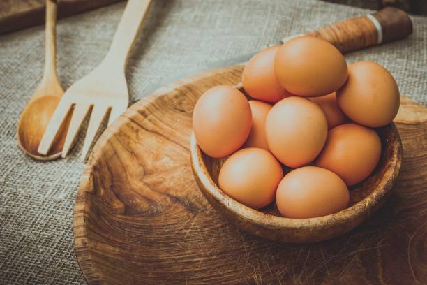 istock Eggs in a wooden bowl on the table. 687698492