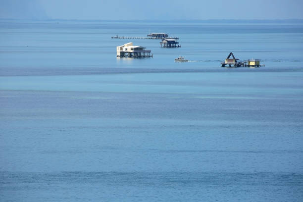 Aerial view of Stiltsville, located one mile south of Bill Baggs Cape State Park in Florida.  These isolated  homes stand on wood or reinforced concrete pilings, accessible only by water.