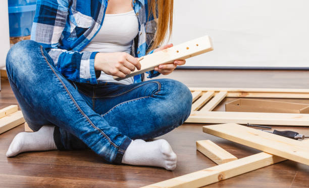 istock Woman assembling wood furniture. DIY. 687701464