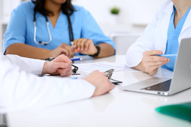 istock Group of doctors discuss at meeting 687702626