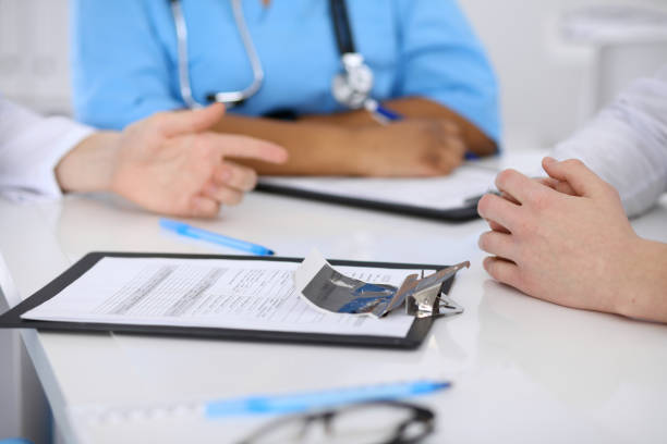 istock Two doctors and male patient discussing medical history 687703502