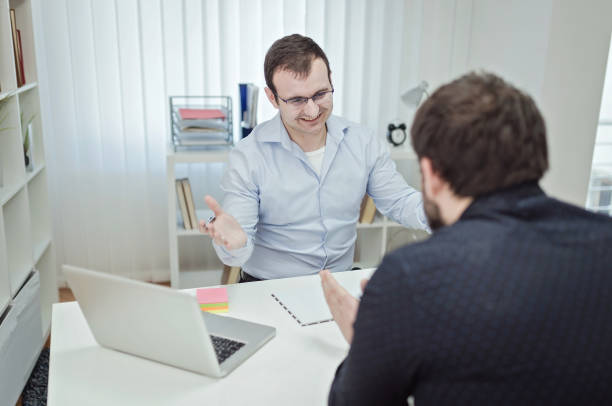 istock Image of two young businessmen discussing data at meeting 687711394