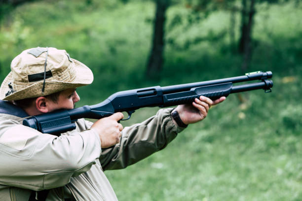 istock Hunter with a gun. Standing in the forest and waiting for prey 687715124