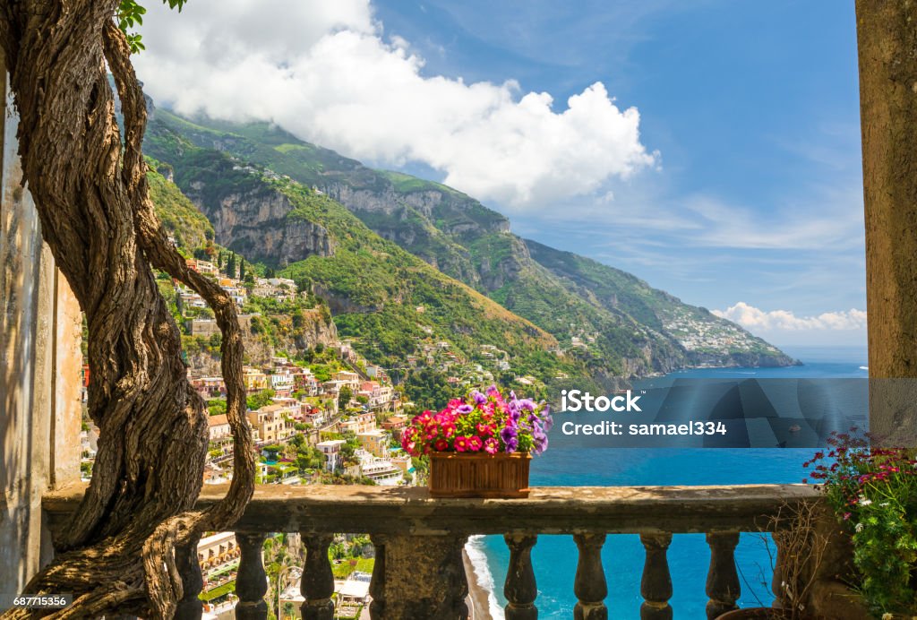 beautiful view of the town of Positano from antique terrace with flowers beautiful view of the town of Positano from antique terrace with flowers, Amalfi coast, Italy. balcony with flowers Italy Stock Photo