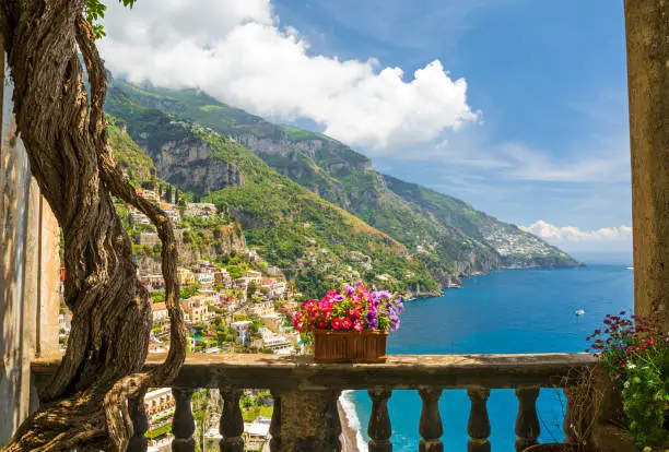 Photo of beautiful view of the town of Positano from antique terrace with flowers