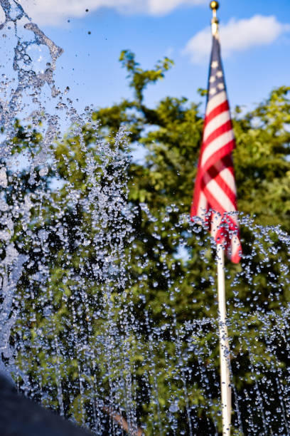 American Flag Behind Water Fountain