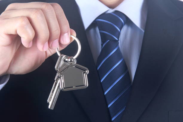 istock Businessman hand holding house key 687716486