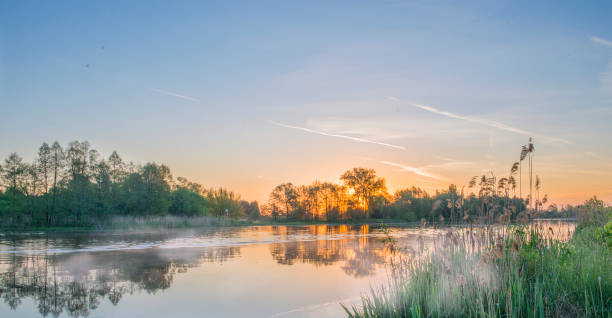 istock Dawn over the river in silent summer day. 687719148