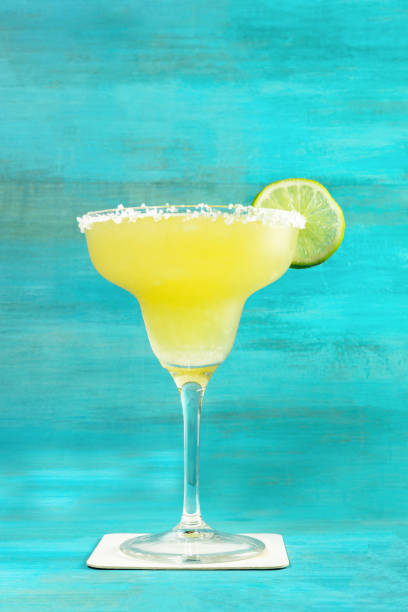 istock Lemon Margarita cocktail on vibrant turquoise with copyspace 687726174