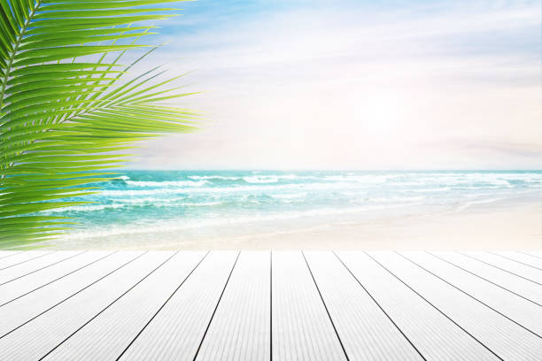 istock old wood table top on blurred beach background. 687726282