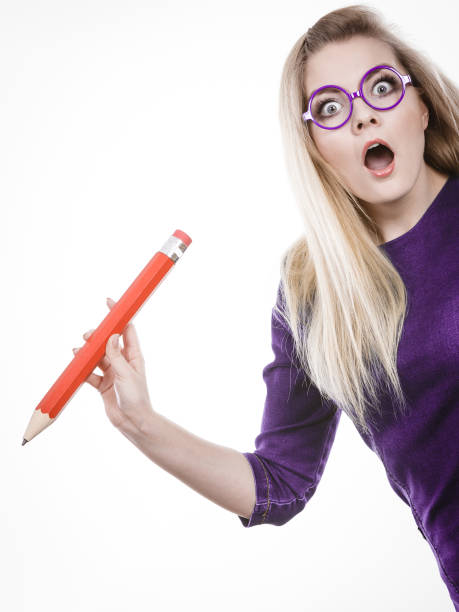 istock Shocked woman holds big pencil in hand 687729094