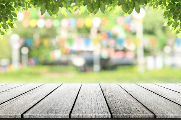istock Empty wooden table with party in garden background blurred. 687729328