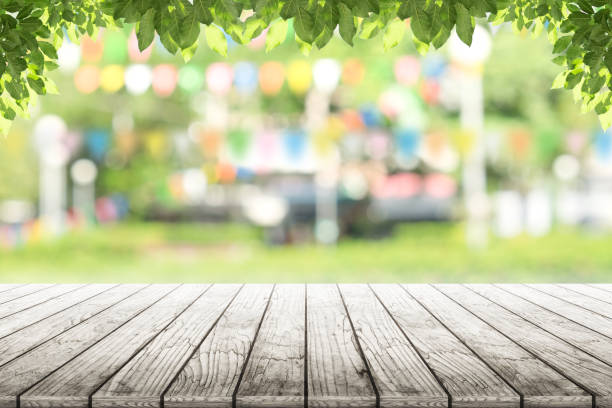 istock Empty wooden table with party in garden background blurred. 687730354