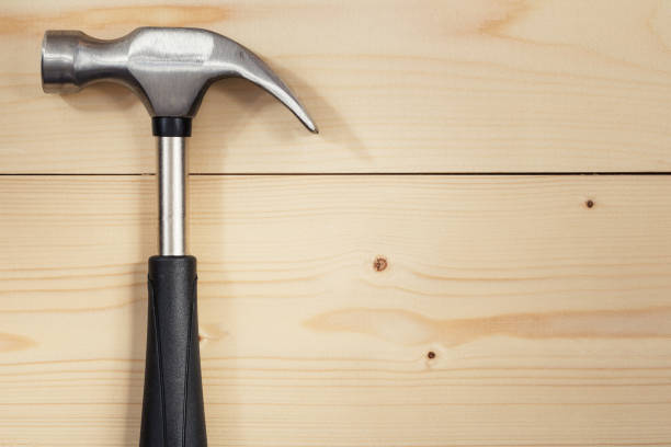 istock Steel hammer on a wooden table. Flat lay. Copy space. Color toning. 687732344