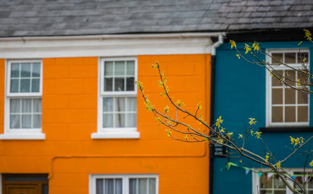 Orange and blue home facades in a small picturesque irish town Sneem on the Ring of Kerry route, Ireland