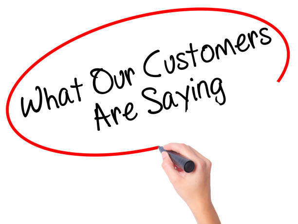 Women Hand writing What Our Customers Are Saying with black marker on visual screen