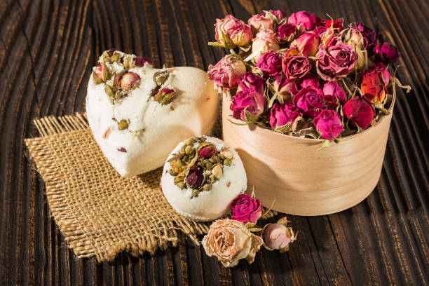 istock Bomb salt bath decorated with dried roses on a wooden background 687738738