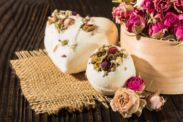 istock Bomb salt bath decorated with dried roses on a wooden background 687739216