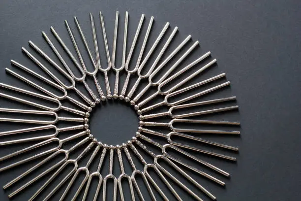 Tuning fork round pattern on a black background