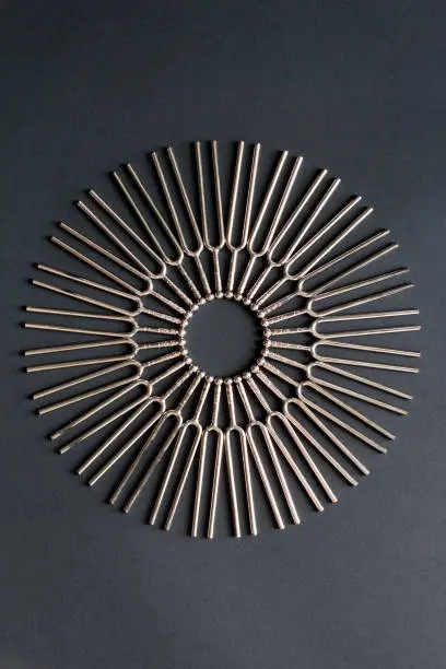 Tuning fork round pattern on a black background