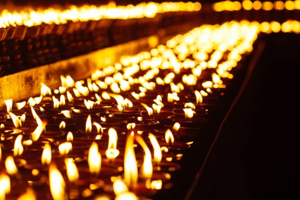 istock Many candle flames glowing in the dark 687741928