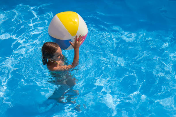 istock Girl playing in the swimming pool 687742840