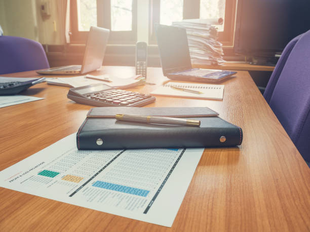 istock Close up of pen on notebook in conference room 687745234